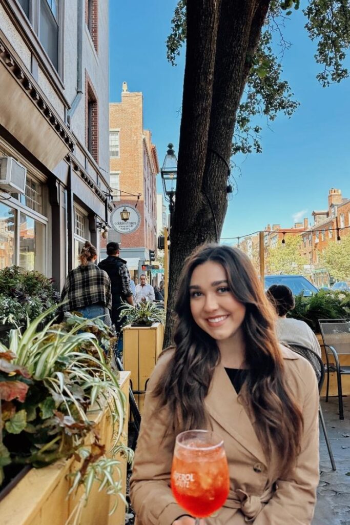 Ava sitting outside at a restaurant in Beacon Hill