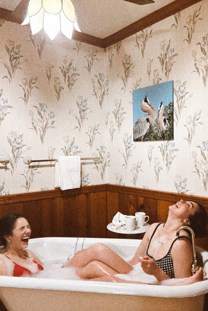 Ava and Camille enjoying the clawfoot tub at Sandaway Suites and Beach