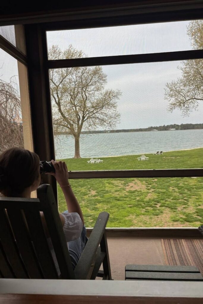 Camille looking through binoculars on Sandaway Suites & Beach deck