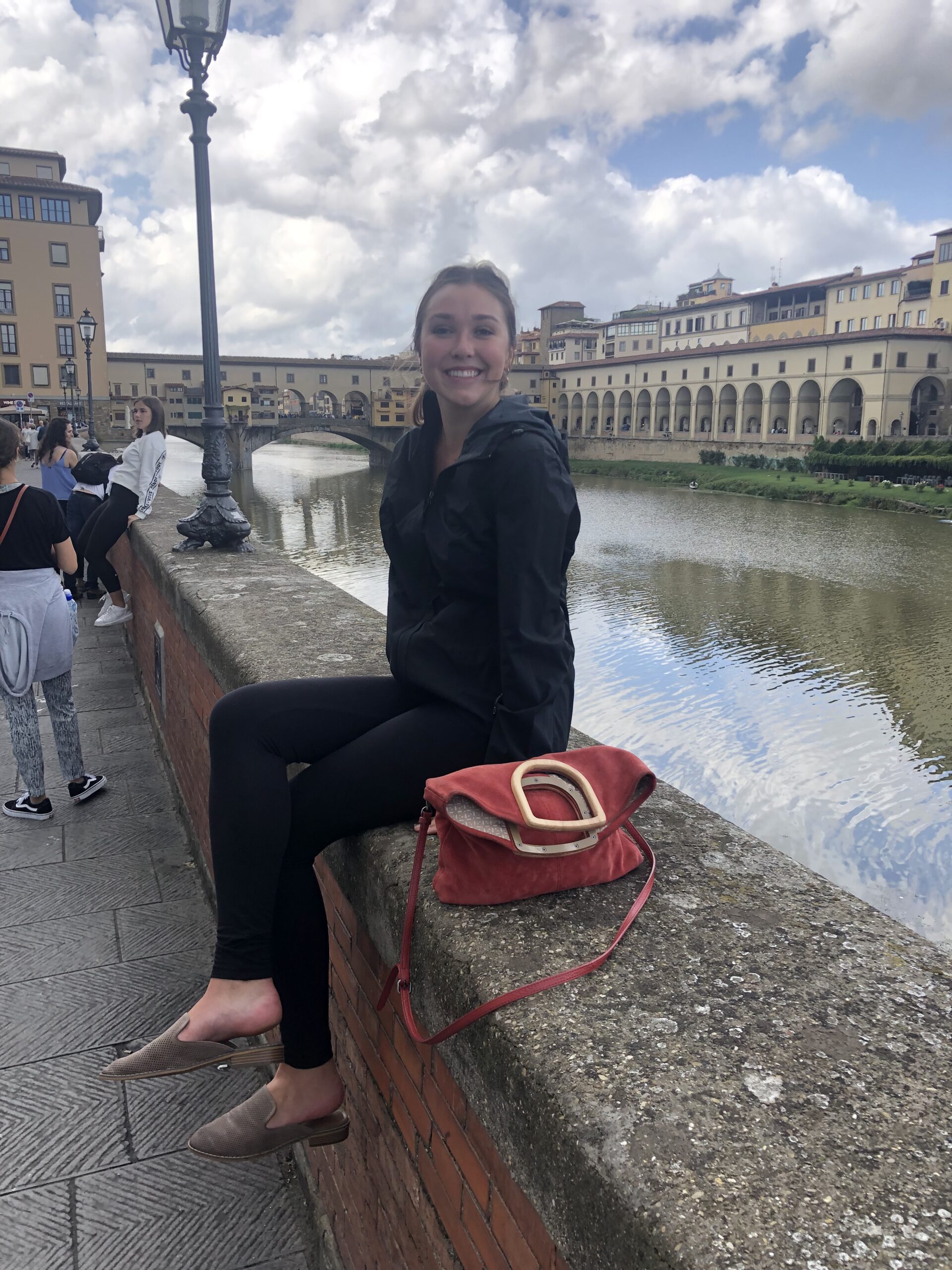 Ava sitting on a bridge in Florence Italy