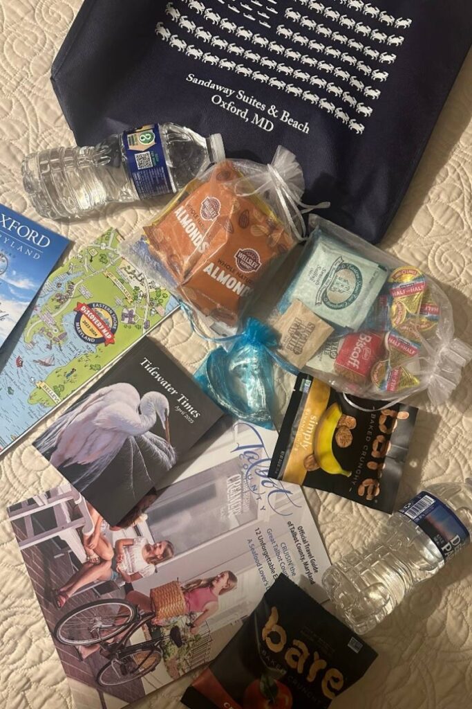 Sandaway Suites & Beach Goodies laid out on the bed