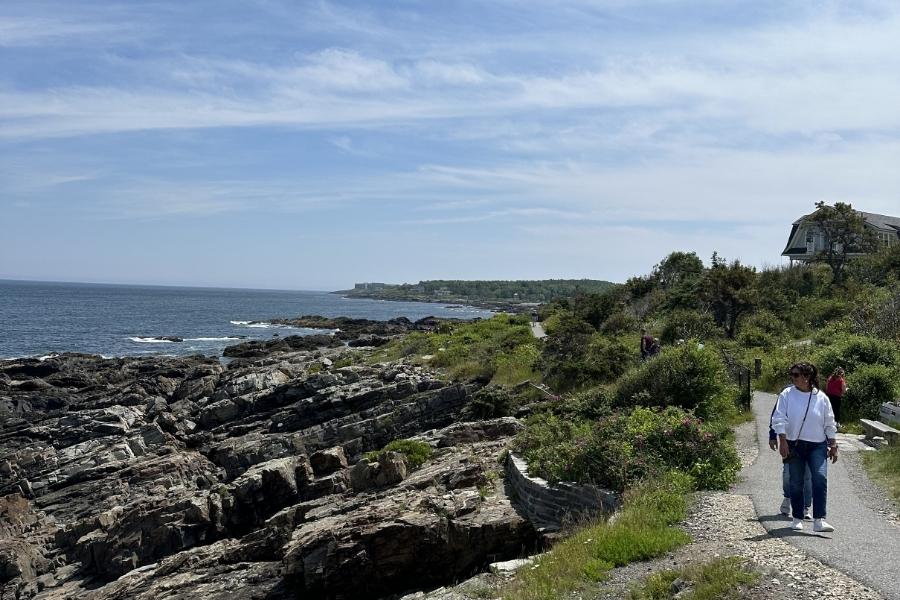 Maine beach towns - woman walking on the beach